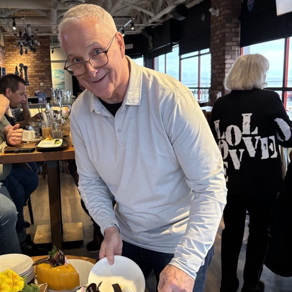 Bob Dowbiggin smiling at a gathering with friends