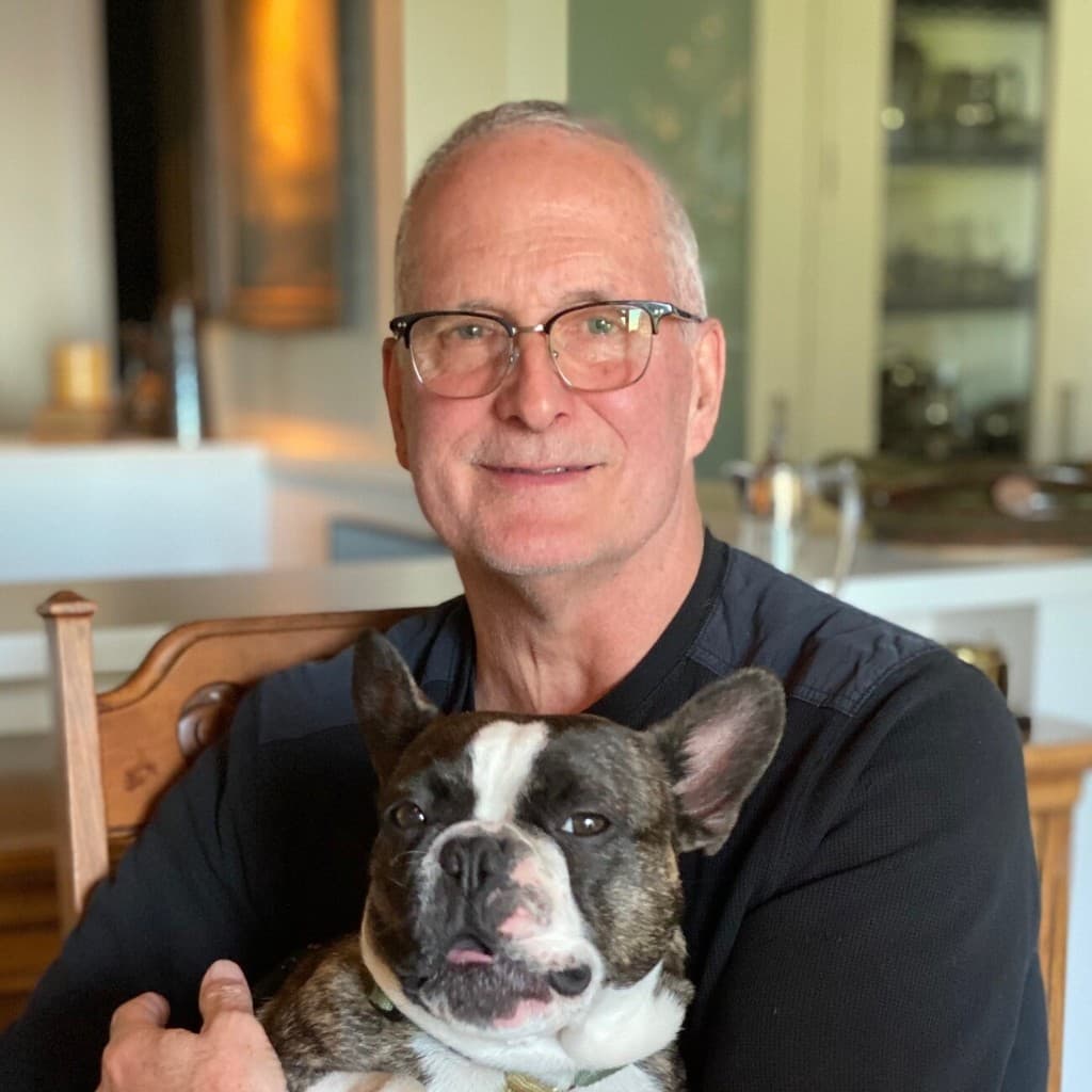 Bob Dowbiggin at home with his French bulldog