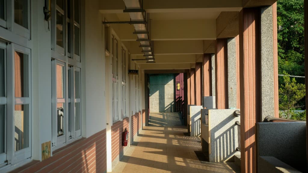 Covered school corridor with windows and tiled walkways, typical of BC campus buildings